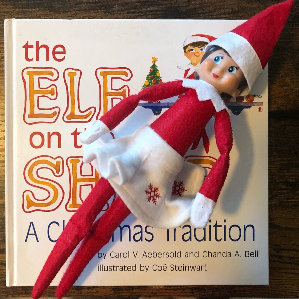 Elf on a shelf (she) with book